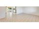 Bright living room with tile floors, leading into kitchen and outdoor patio area at 10891 W Clair Dr, Sun City, AZ 85351