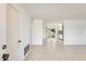 Open-concept living space with tile floors, leading to a bright kitchen and covered patio at 10891 W Clair Dr, Sun City, AZ 85351