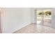 Bright living room with tile floors and sliding glass doors to the outdoor patio area at 10891 W Clair Dr, Sun City, AZ 85351