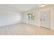 Bright living room featuring tile floors and a decorative front door with leaded glass window at 10891 W Clair Dr, Sun City, AZ 85351