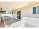 Covered patio with tiled floor, decorative concrete border, and sliding door access to the interior at 10891 W Clair Dr, Sun City, AZ 85351