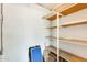 Functional storage area with shelving units against a white brick wall, perfect for organizing household items at 10891 W Clair Dr, Sun City, AZ 85351