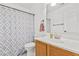 Charming bathroom featuring a vanity with wood cabinets and patterned shower curtain at 1114 S Grenoble --, Mesa, AZ 85208