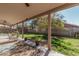 Relaxing covered patio featuring neutral tones, ceiling fans, and view of lush backyard at 1114 S Grenoble --, Mesa, AZ 85208