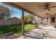 Expansive covered patio overlooking landscaped backyard with mature trees and brick wall at 1114 S Grenoble --, Mesa, AZ 85208