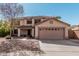 Home with desert landscaping, two-car garage, and a cozy covered front porch area at 1114 S Grenoble --, Mesa, AZ 85208