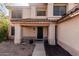 Inviting front porch with decorative pillars and well-placed potted plants at 1114 S Grenoble --, Mesa, AZ 85208