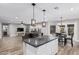 Open concept kitchen featuring island, stone countertops, and pendant lighting at 1114 S Grenoble --, Mesa, AZ 85208