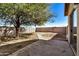 Backyard featuring a large shade tree and private block fencing at 11354 W Carousel Dr, Arizona City, AZ 85123