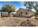 Spacious backyard featuring rock landscaping, privacy fence, and mature tree at 11354 W Carousel Dr, Arizona City, AZ 85123