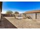 View of the backyard featuring rock landscaping and a concrete pad at 11354 W Carousel Dr, Arizona City, AZ 85123