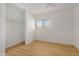 Bedroom featuring wood-style flooring, a closet, and neutral decor at 11354 W Carousel Dr, Arizona City, AZ 85123