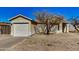 Single story house with a two car garage, tree, and low maintenance landscaping at 11354 W Carousel Dr, Arizona City, AZ 85123