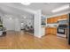 Open concept living room with hardwood floors, and stainless steel appliances in the kitchen at 11354 W Carousel Dr, Arizona City, AZ 85123