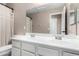 Bathroom featuring double sinks and vanities with chrome fixtures and a large mirror at 11457 W Madisen Ellise Dr, Surprise, AZ 85378