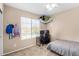 Cozy bedroom featuring a bright window, neutral walls, and a comfortable sleeping and work area at 11457 W Madisen Ellise Dr, Surprise, AZ 85378