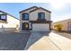 Charming two-story home with a two-car garage and a well-manicured lawn on a bright sunny day at 11457 W Madisen Ellise Dr, Surprise, AZ 85378