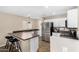 Well-lit kitchen featuring stainless steel appliances, white cabinets, and a breakfast bar area at 11457 W Madisen Ellise Dr, Surprise, AZ 85378