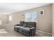 Living room view showcasing a large window and a gray couch at 11457 W Madisen Ellise Dr, Surprise, AZ 85378