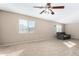 Living room featuring a ceiling fan, a large window, and gray furniture at 11457 W Madisen Ellise Dr, Surprise, AZ 85378