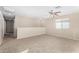 Neutral loft area with a ceiling fan, carpeted floors, and natural light at 11457 W Madisen Ellise Dr, Surprise, AZ 85378