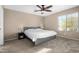 Bedroom features a window and side tables with lamps at 11457 W Madisen Ellise Dr, Surprise, AZ 85378