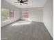 Bright carpeted bedroom with abundant natural light from two windows at 11595 W Holly St, Avondale, AZ 85392