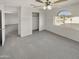 Bedroom with a large closet, neutral carpet, and bright window view at 11595 W Holly St, Avondale, AZ 85392