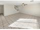 Open living room with neutral paint, tile flooring, and a ceiling fan at 11595 W Holly St, Avondale, AZ 85392