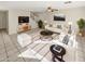 Bright living room featuring modern furniture, a ceiling fan, and tile flooring at 11595 W Holly St, Avondale, AZ 85392