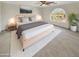 Cozy main bedroom featuring an arched window and a plush carpet at 11595 W Holly St, Avondale, AZ 85392