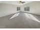 Expansive main bedroom with carpet flooring and two large windows for natural light at 11595 W Holly St, Avondale, AZ 85392