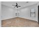 Bright living room with tile floors, ceiling fan, and large windows with plenty of natural light at 11910 W Daley Ct, Sun City, AZ 85373