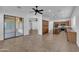 Spacious living room with a tile floor, fireplace, ceiling fans, and sliding glass doors at 11910 W Daley Ct, Sun City, AZ 85373