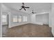 Spacious, bright living room with tile floors, large windows, and ceiling fans at 11910 W Daley Ct, Sun City, AZ 85373