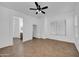 Bright living room with tile floors, ceiling fan, and open access to other spaces in the home at 11910 W Daley Ct, Sun City, AZ 85373