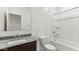 Bathroom featuring dark wood vanity with granite countertop and shower-tub combo at 11928 E Aster Ln, Florence, AZ 85132