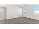 Neutral bedroom with plush carpeting, bright natural light, and adjacent bathroom access at 11928 E Aster Ln, Florence, AZ 85132