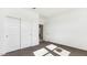 Carpeted bedroom with bright light, baseboards, closet and doorway at 11928 E Aster Ln, Florence, AZ 85132