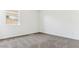 Bedroom with carpet, baseboards, and bright light from the window at 11928 E Aster Ln, Florence, AZ 85132