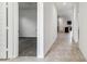 Inviting hallway with neutral tile flooring leading to an open bedroom with plush carpeting at 11928 E Aster Ln, Florence, AZ 85132