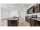 Modern kitchen with a granite island, dark cabinetry, and stainless steel appliances at 11928 E Aster Ln, Florence, AZ 85132