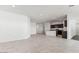 Spacious living room featuring tile floors, recessed lighting, and an open layout into the kitchen at 11928 E Aster Ln, Florence, AZ 85132