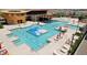 Aerial view of a multi-pool complex with sun loungers and tables at 11928 E Aster Ln, Florence, AZ 85132