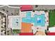 Aerial view of community pool with zero entry, splash pad, umbrellas, and resort amenities at 11980 E Aster Ln, Florence, AZ 85132