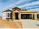 New construction home featuring wood framing, a concrete driveway, and Thermo-Sheath structural sheathing at 11980 E Aster Ln, Florence, AZ 85132