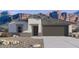 Charming single-story home featuring desert landscaping, a two-car garage, and picturesque mountain views at 11980 E Aster Ln, Florence, AZ 85132