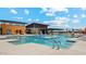 Large community pool and amenity center with lane lines and lounge seating at 11980 E Aster Ln, Florence, AZ 85132