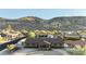 Aerial view of desert home nestled amongst lush landscaping with a mountain backdrop at 1201 W Dahlia Dr, Phoenix, AZ 85029