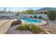 Tranquil backyard with a private pool surrounded by lush landscaping and stonework at 1201 W Dahlia Dr, Phoenix, AZ 85029